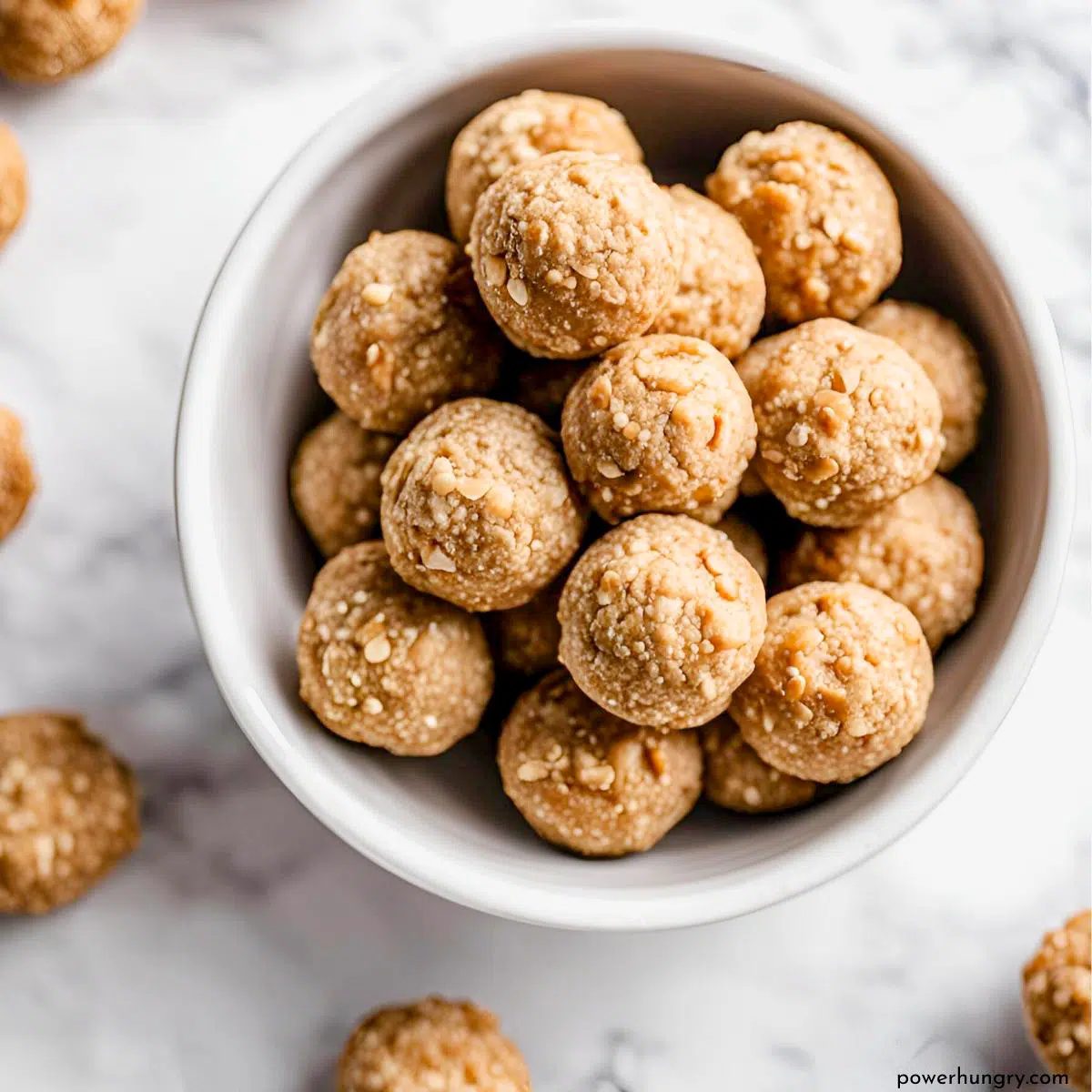 white bowl filled with cookie dough protein balls