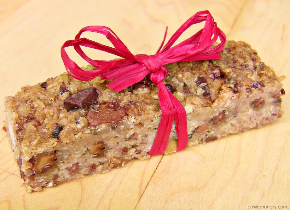protein bar, tied with a red raffia ribbon, an a cutting board