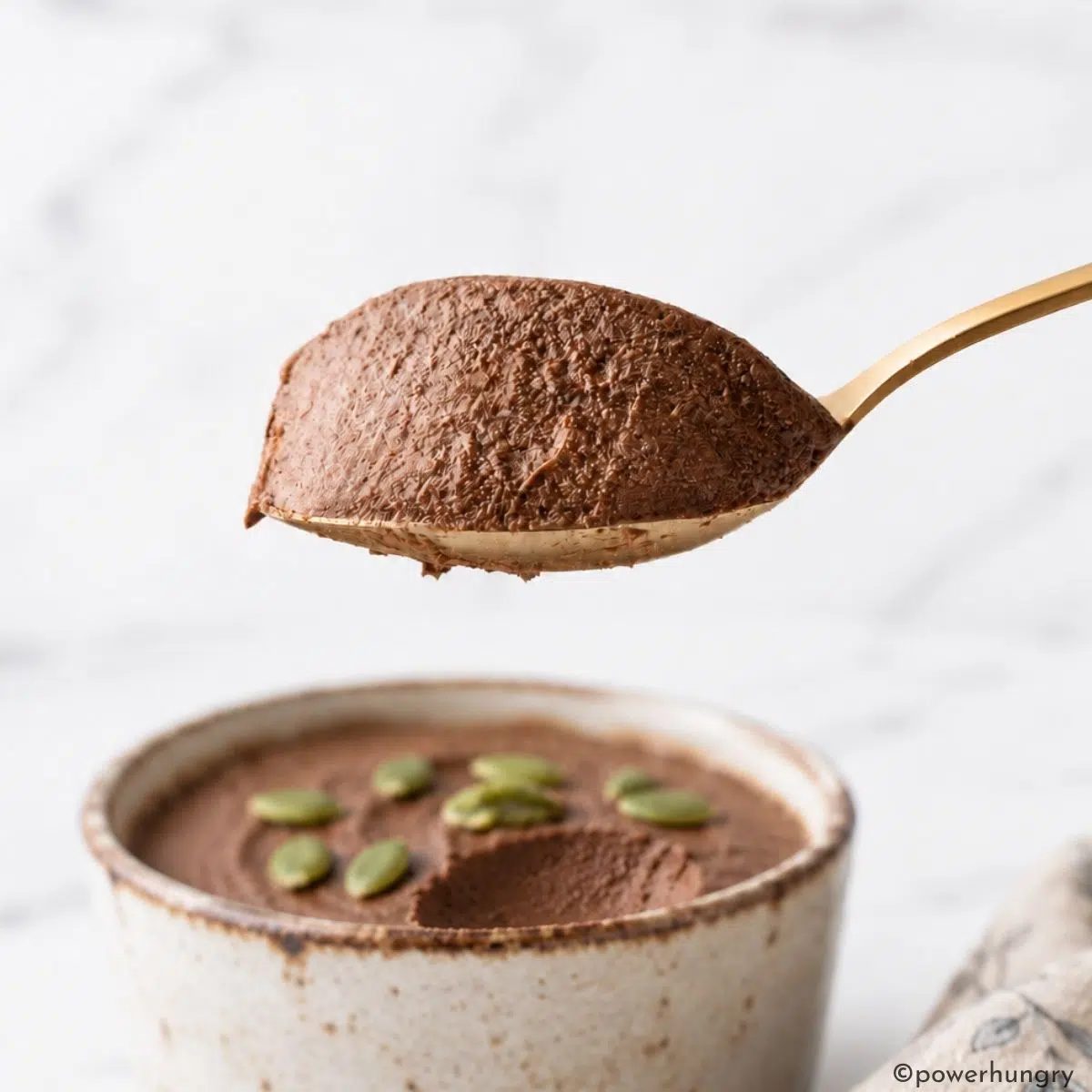 a spoonful of vegan high-protein pumpkin chocolate pudding