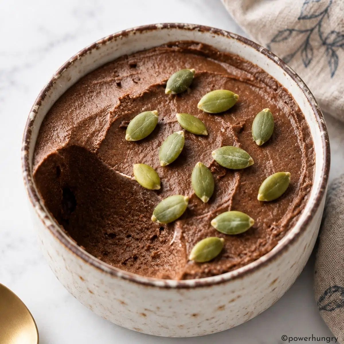 vegan high-protein pumpkin chocolate pudding in a stoneware ramekin