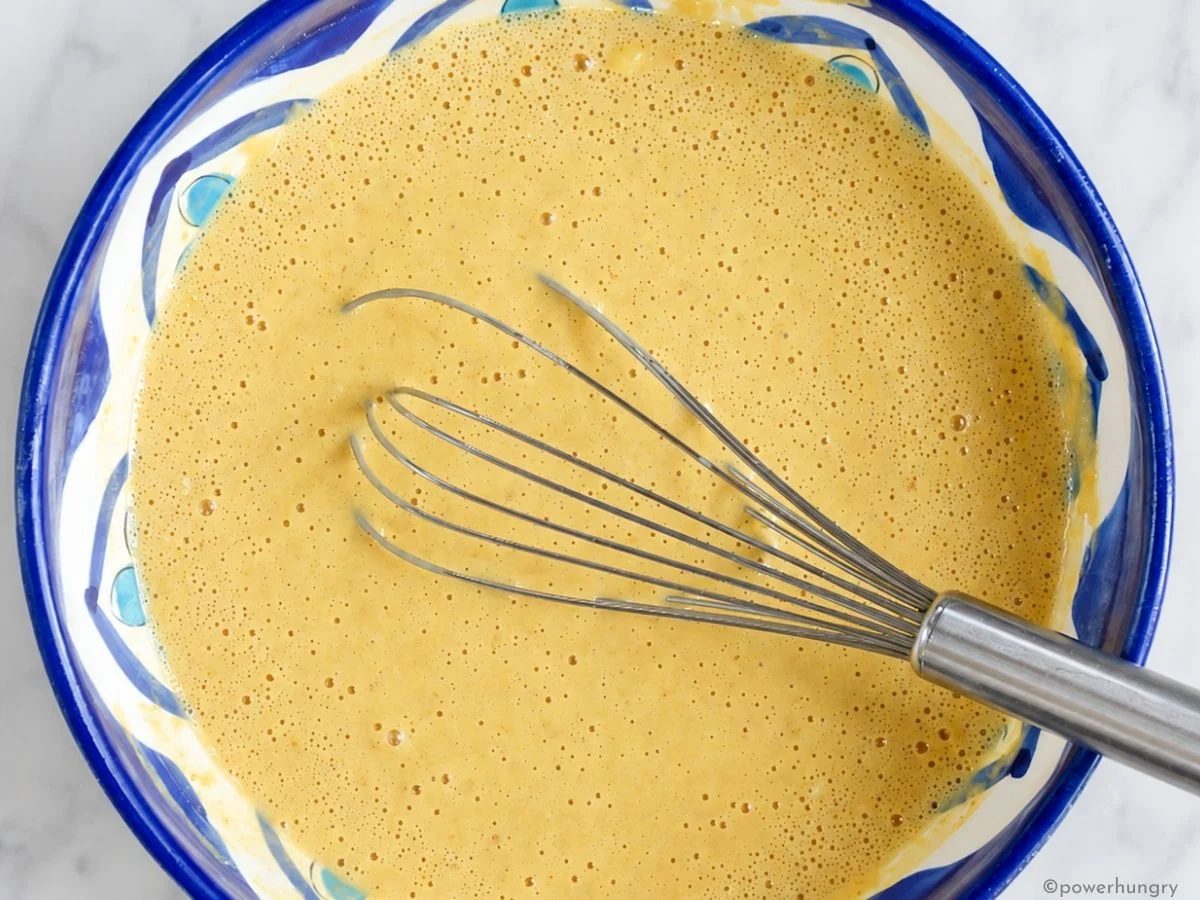 bowl of straightforward no corn cornbread batter in decorative ceramic bowl