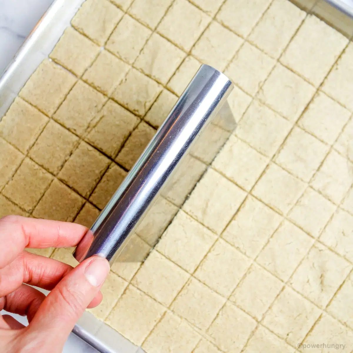 crackers being cut with a pastry scraper