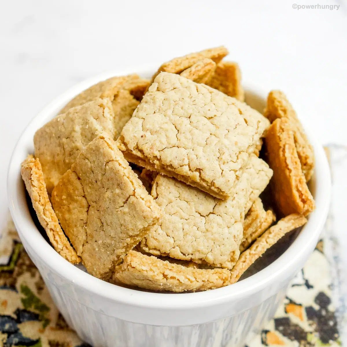 small white bowl filled with oat crackers