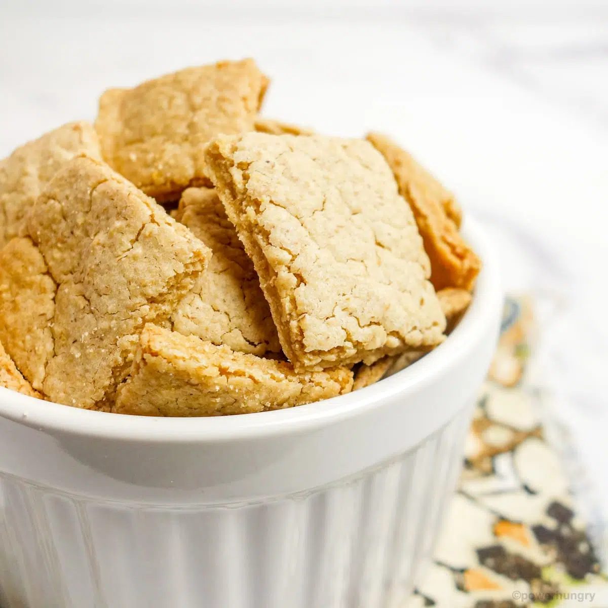 close up of white ramekin filled with no-roll oat crackers