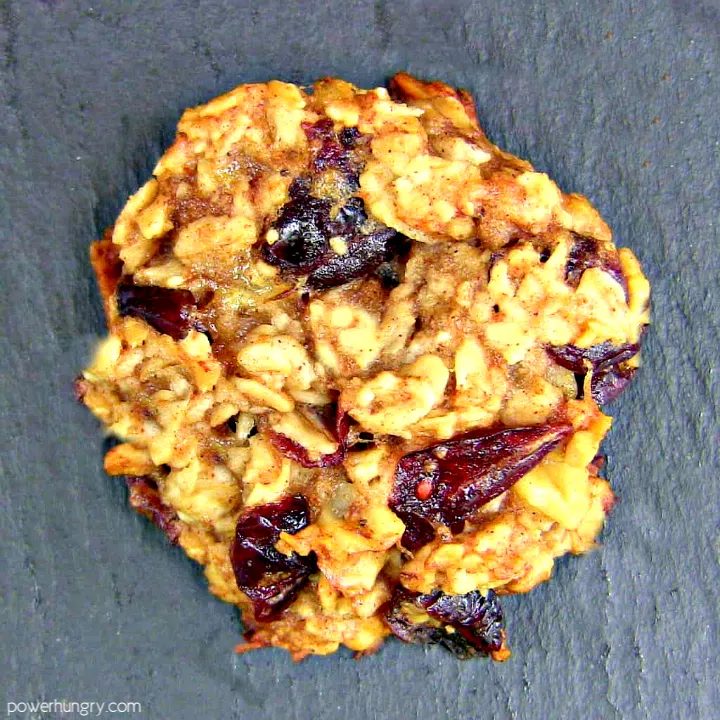 overhead shot of a banana oat coconut oil energy cookie on a piece of slate