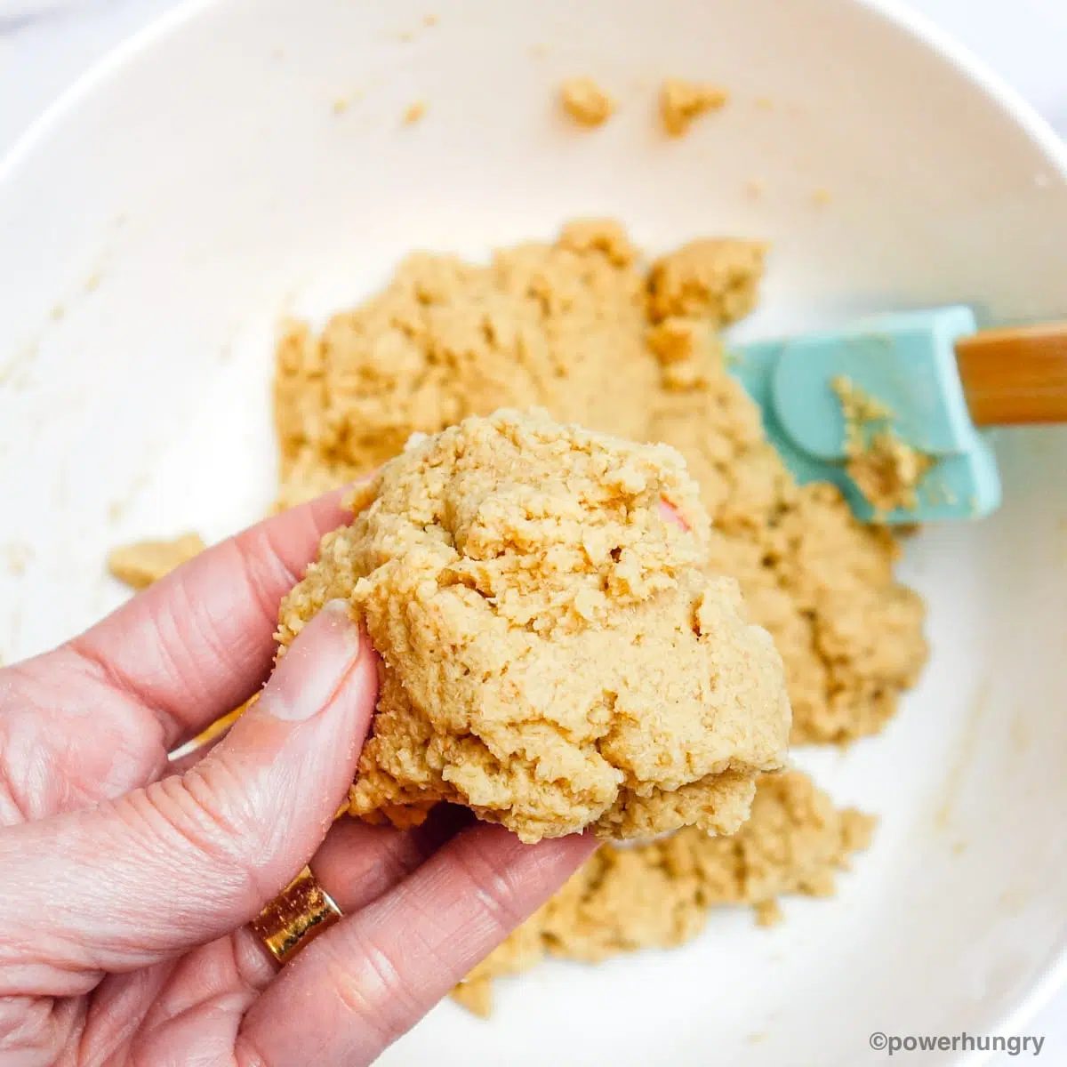 oat fiber tortilla dough being held in a hand