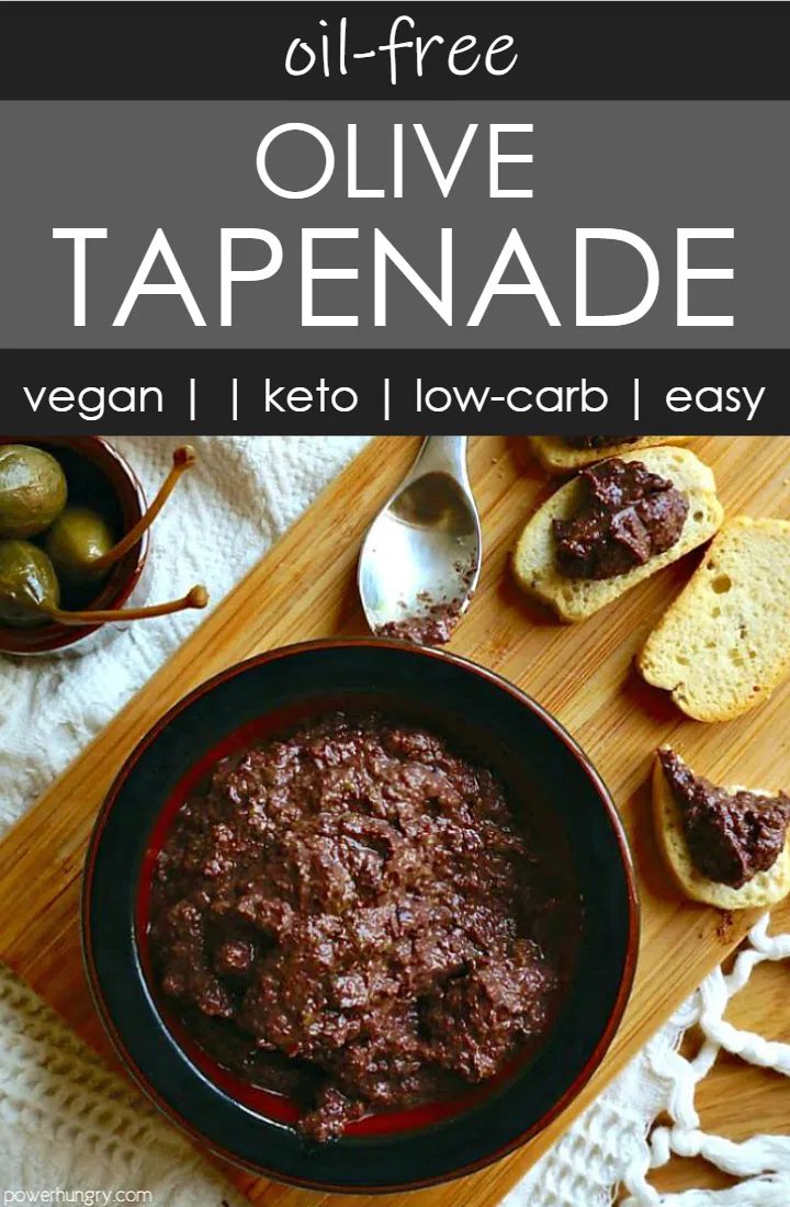 overhead shot of a dark bow l filled with olive tapenade, with a small bowl of capers, and a spoon alongside