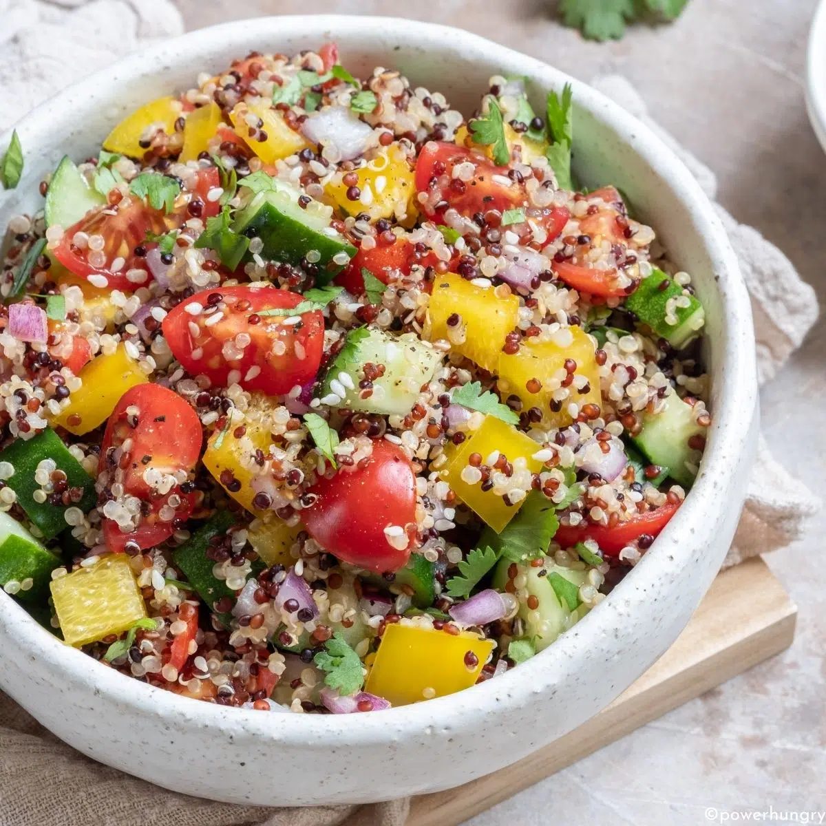 oil-free quinoa salad in a white salad bowl