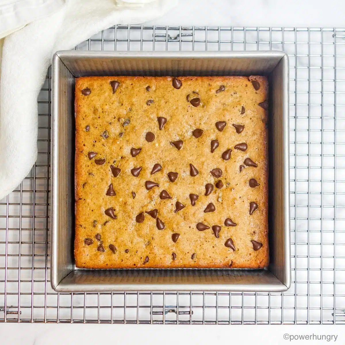 baked vegan oil-free 5 ingredient banana blondies, still in the pan, on a cooling rack