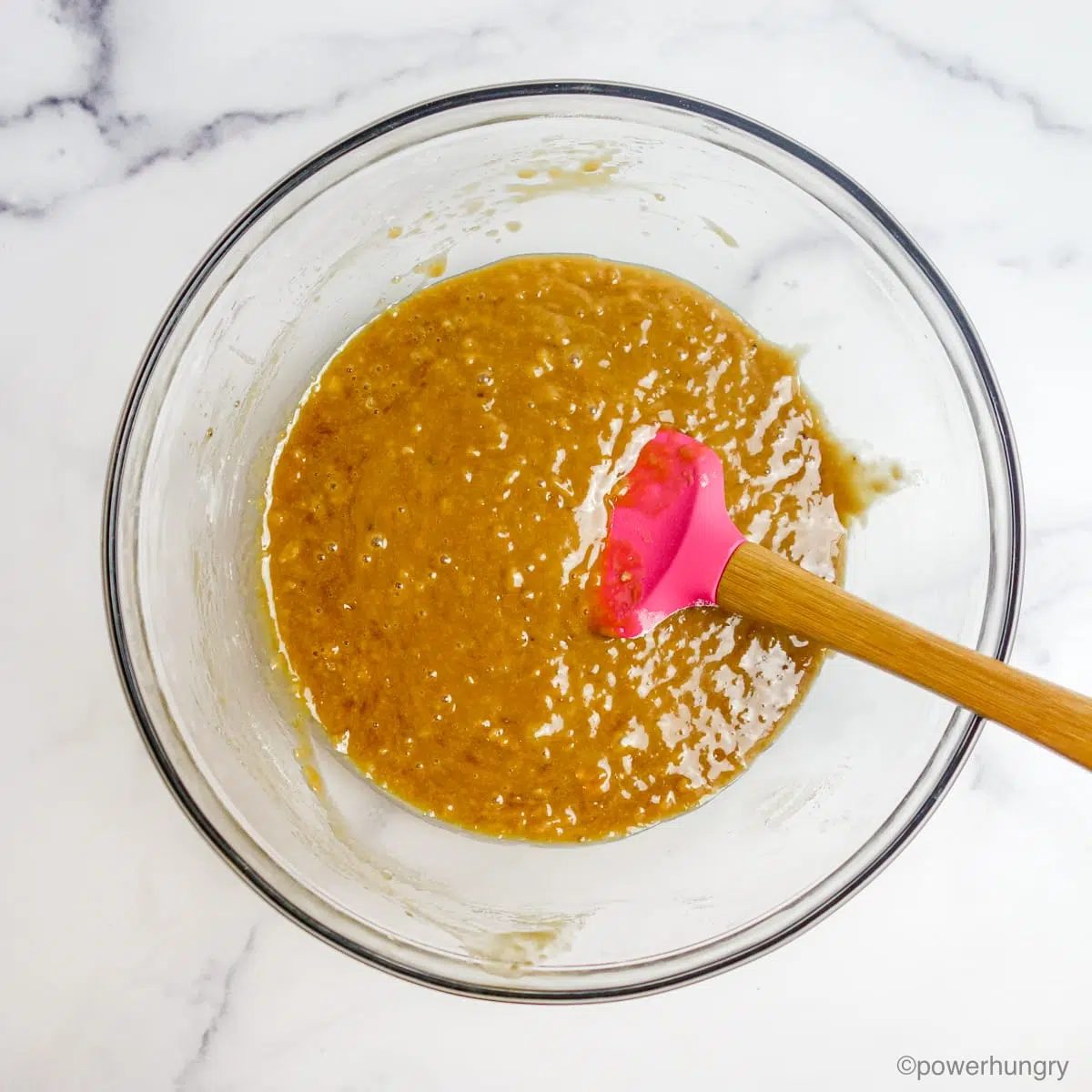 oil-free vegan banna blondie batter in a glass bowl with a pink spatula