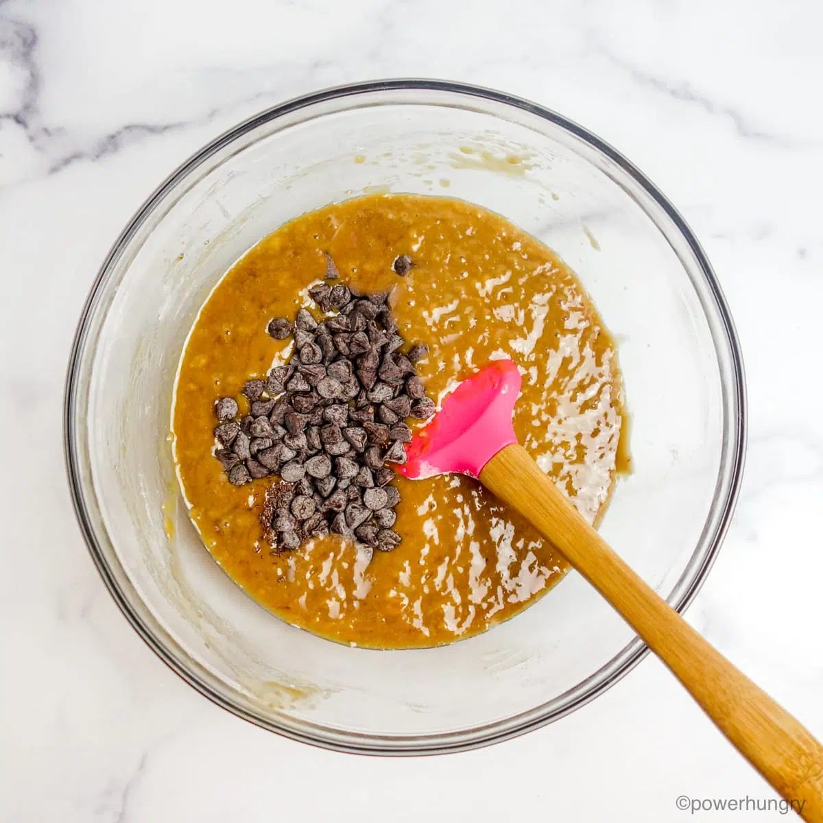 glass bowl filled with oil-free vegan banana blondies and chocolate chips