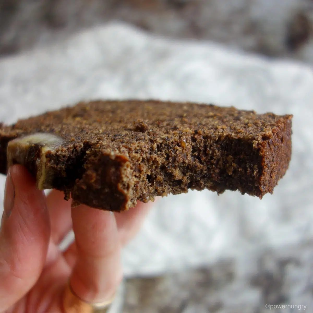 close up of a piece of buckwheat banana bread with a big bite taken out