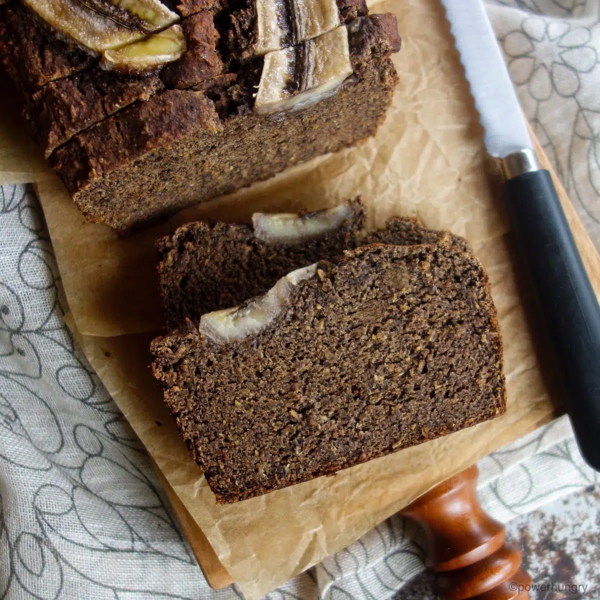 2 slices of oil-free vegan buckwheat banana bread on a wood cutting board