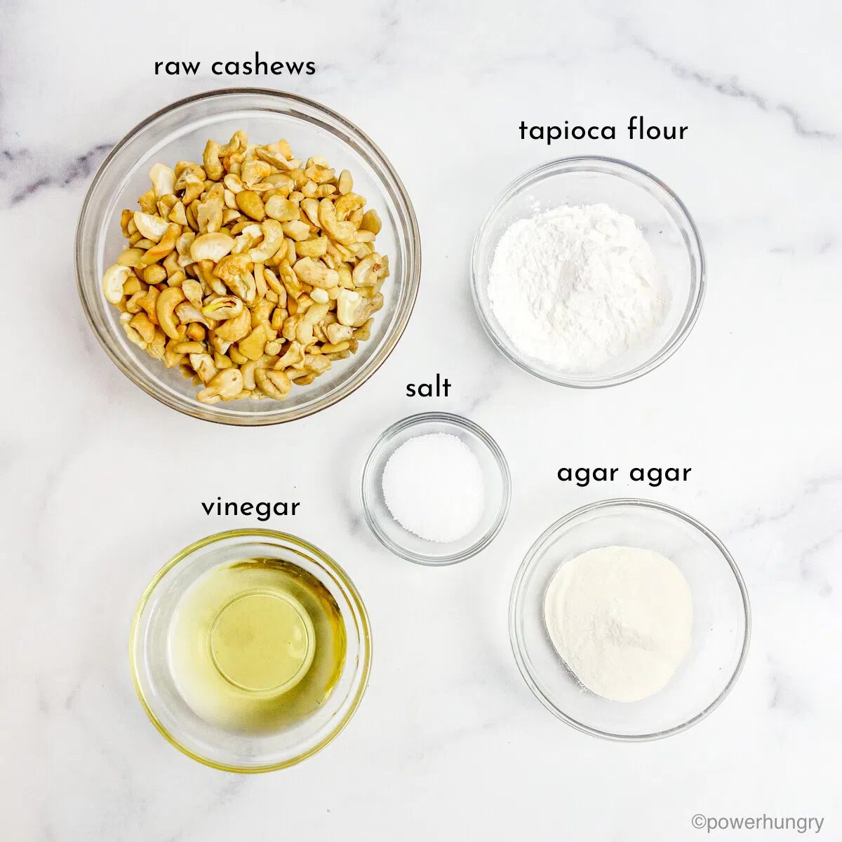 overhead shot of glass bowls filled with the ingredients to make straightforward slice or grate mozzarella cheese