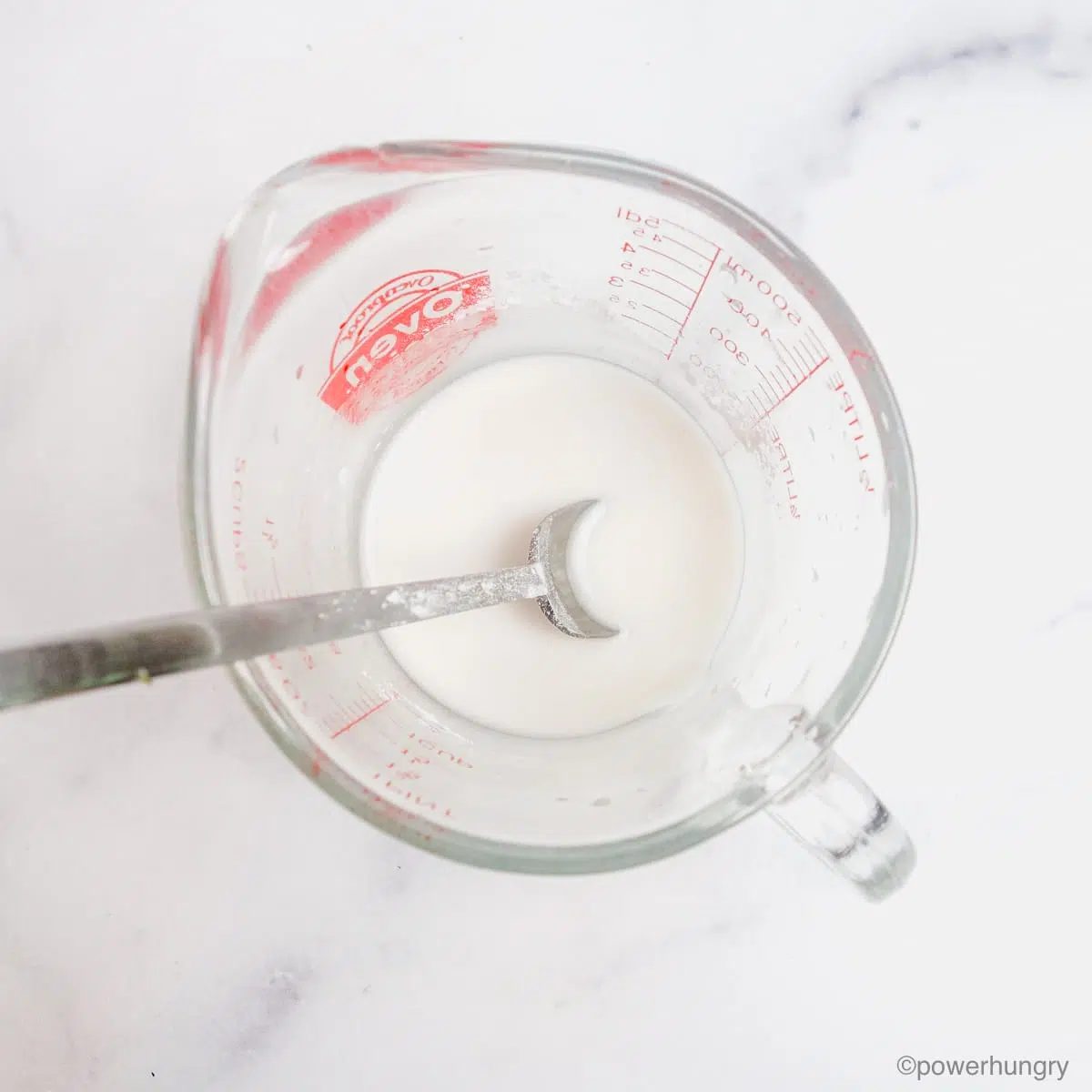 tapioca starch, blended with water, in a glass measuring cup.