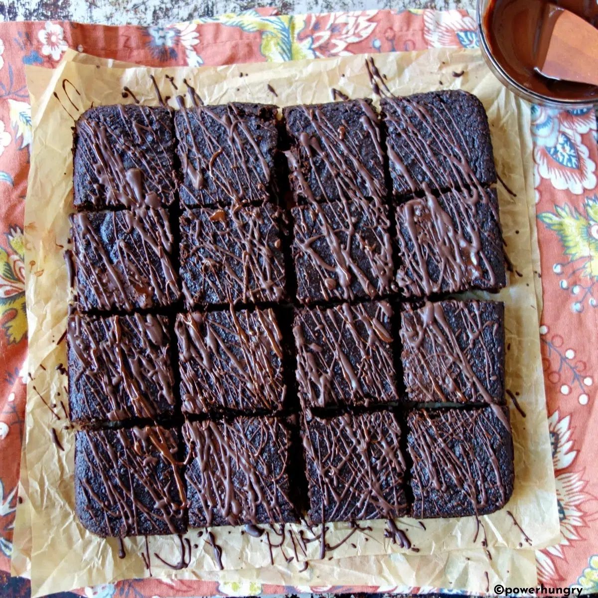 overhead shot of vegan gluten-free brownies drizzled with melted chocolate