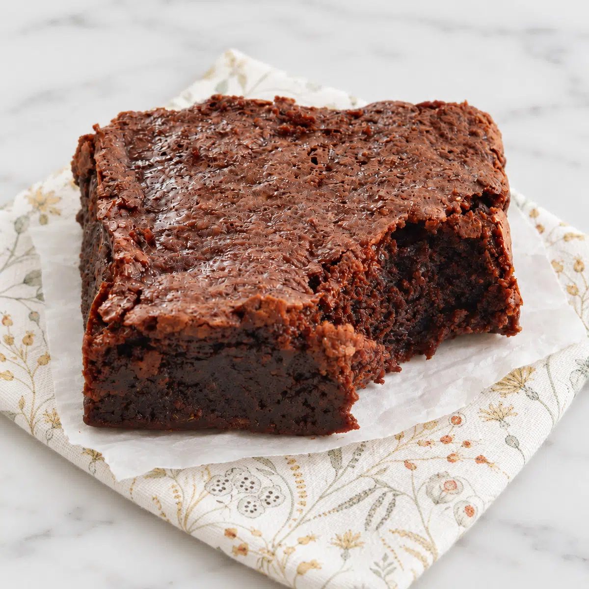 closeup of chickpea flour brownie with a bite taken out