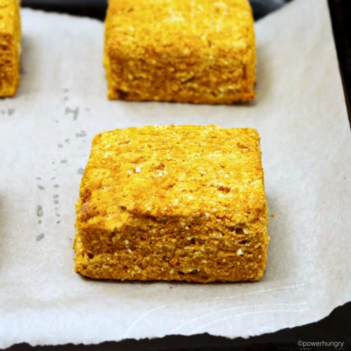 pumpkin coconut flour biscuits on a parchment lined baking sheet