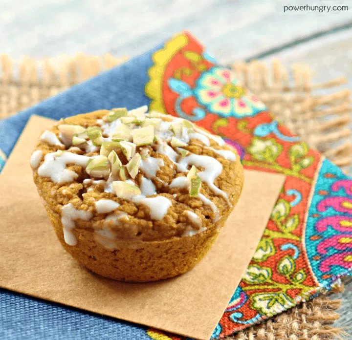 close-up of a vegan pumpkin mini muffin on a piece of parchcment paper