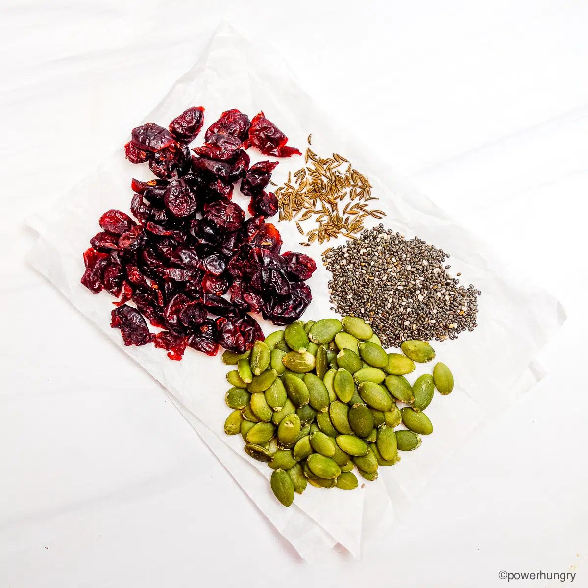 seeds and dried fruit on white background