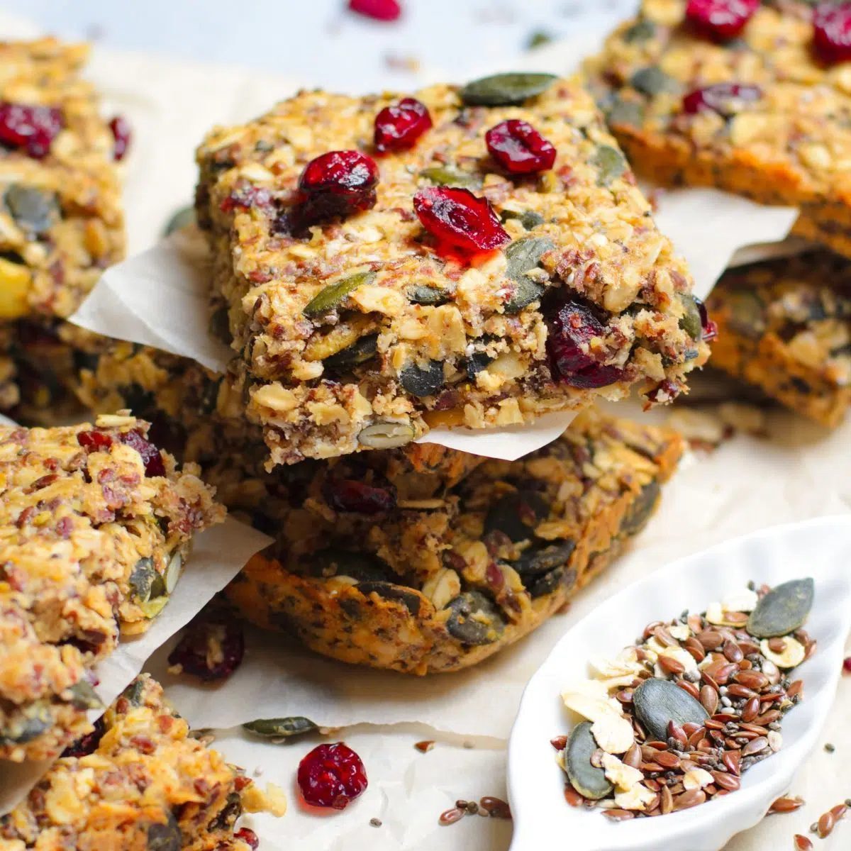 pumpkin oat bars, cut and stacked on parchment paper