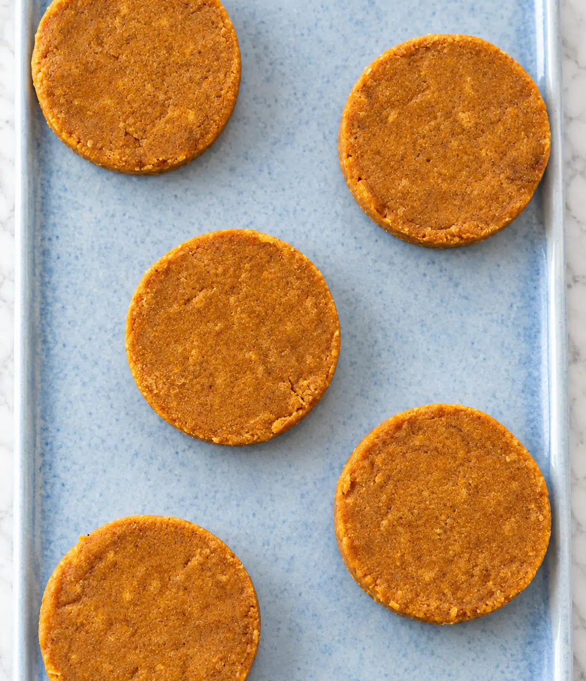 no-bake pumpkin pie protein bars overhead on a blue stoneware platter