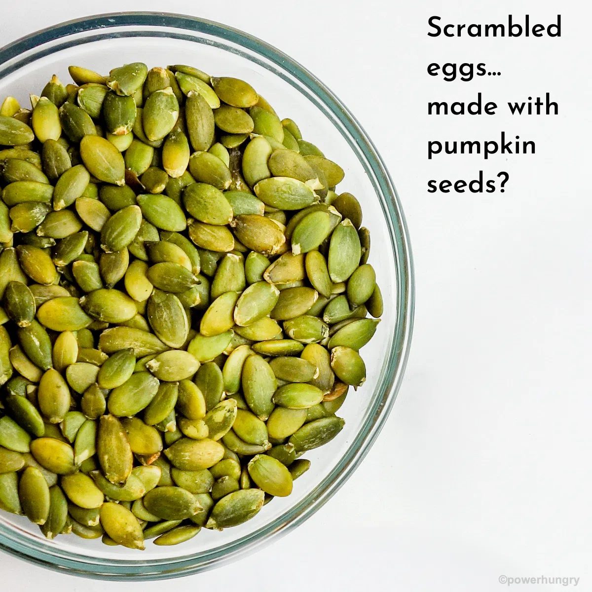 bowl of green pumpkin seeds with white background