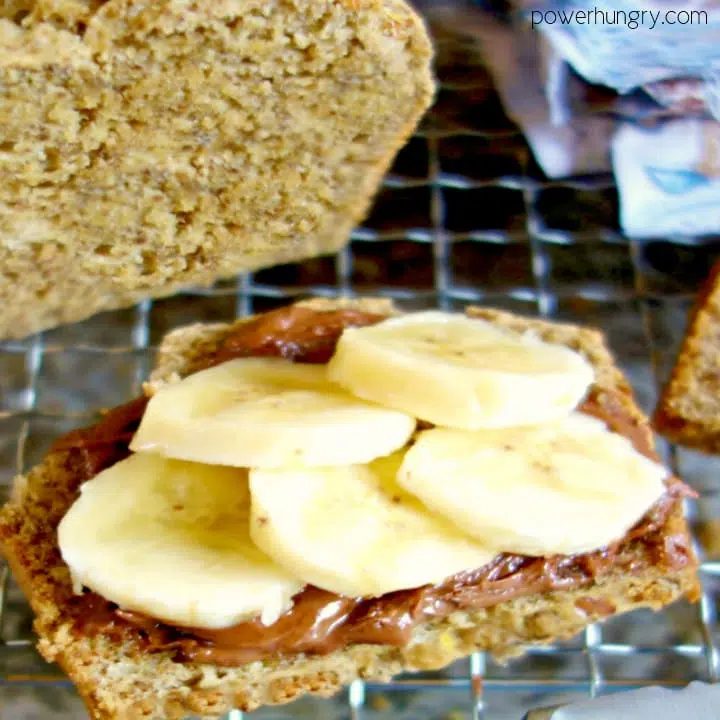 aslice of quinoa and almond soda bread topped with chocolate hazelnut spread and banana slices