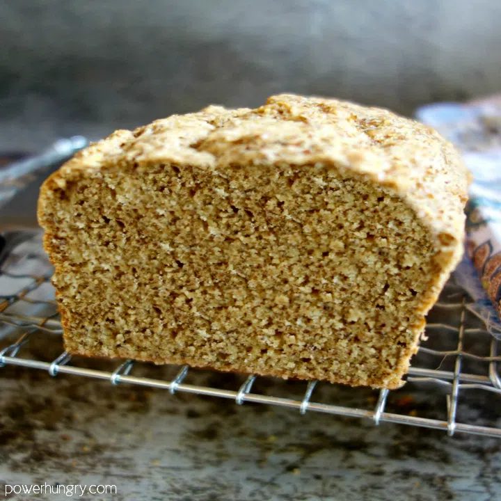 Soda bread made with quinoa flor and almond meal, cooling on a wire rack, sliced to reveal interior texture
