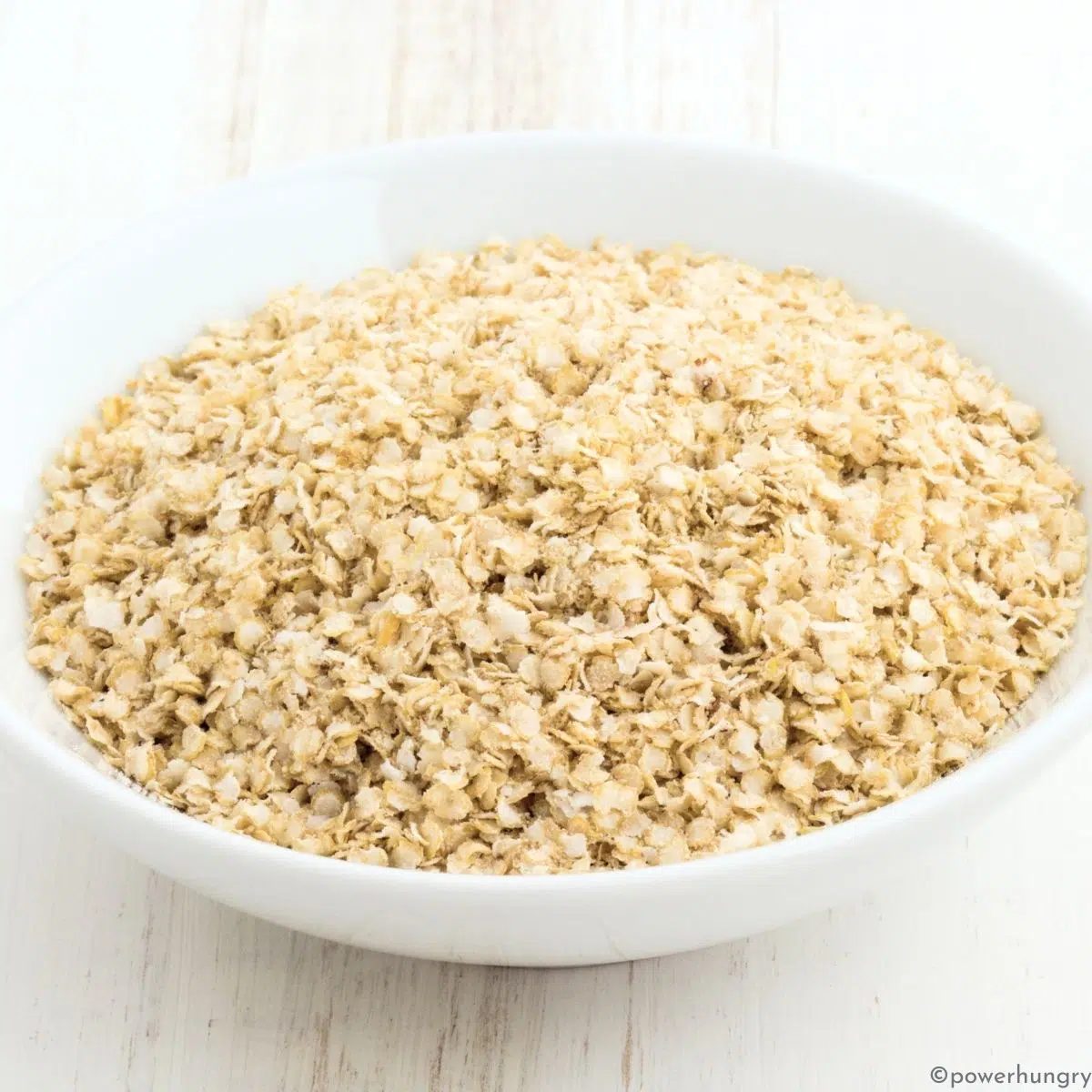 White bowl of quinoa flakes