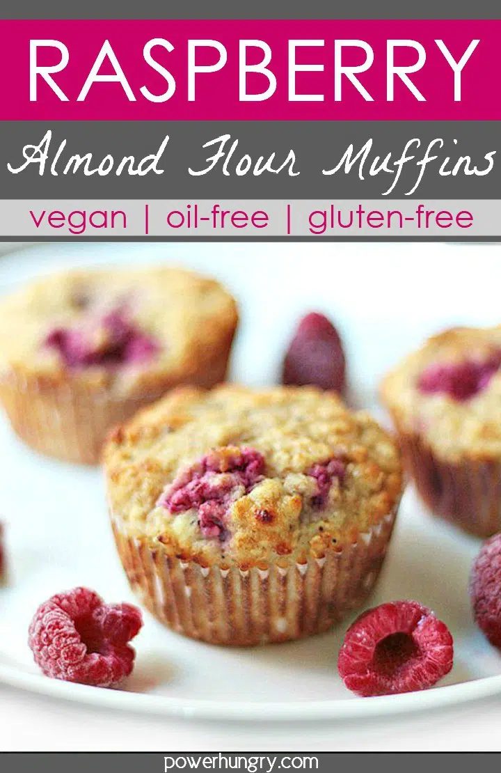 3raspberry almond flour muffins on a white plate with fresh raspberries
