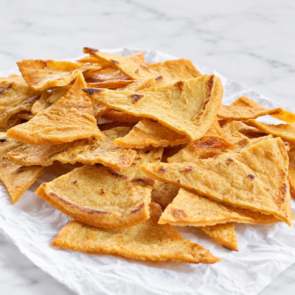 pile of lentil chips on white parchment paper