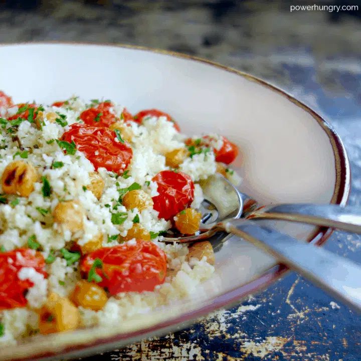 roasted tomato chickpea and cauliflower salad in a white bowl