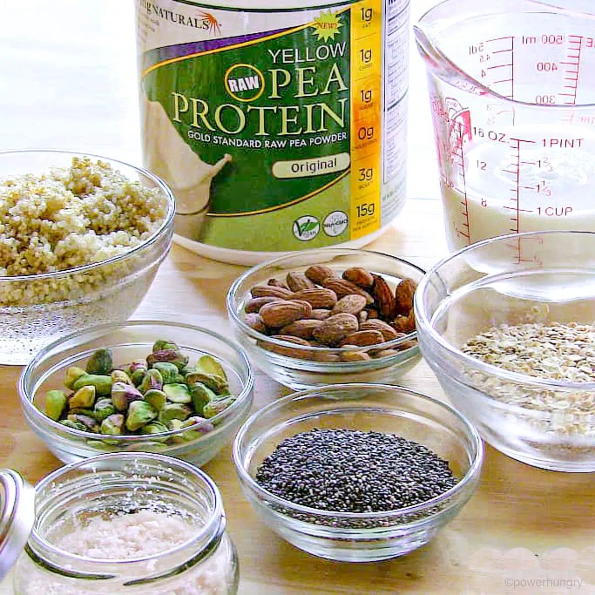 glass bowls and jars filled with the ingredients for savory vegan protein bars