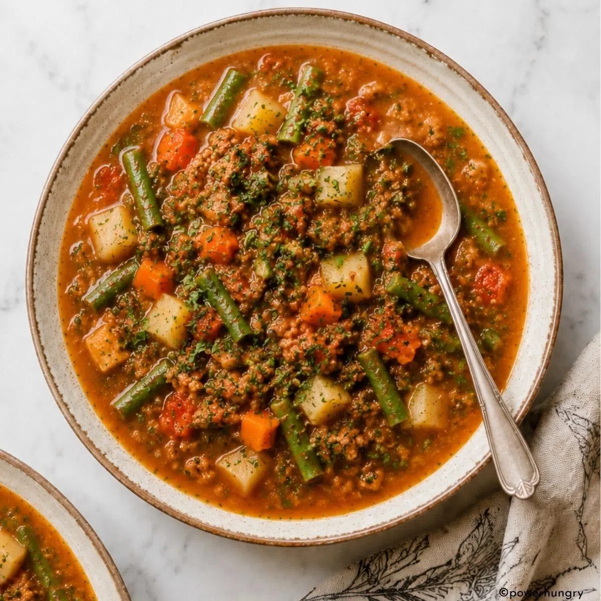slow cooker vegan hamburger soup with a spoon