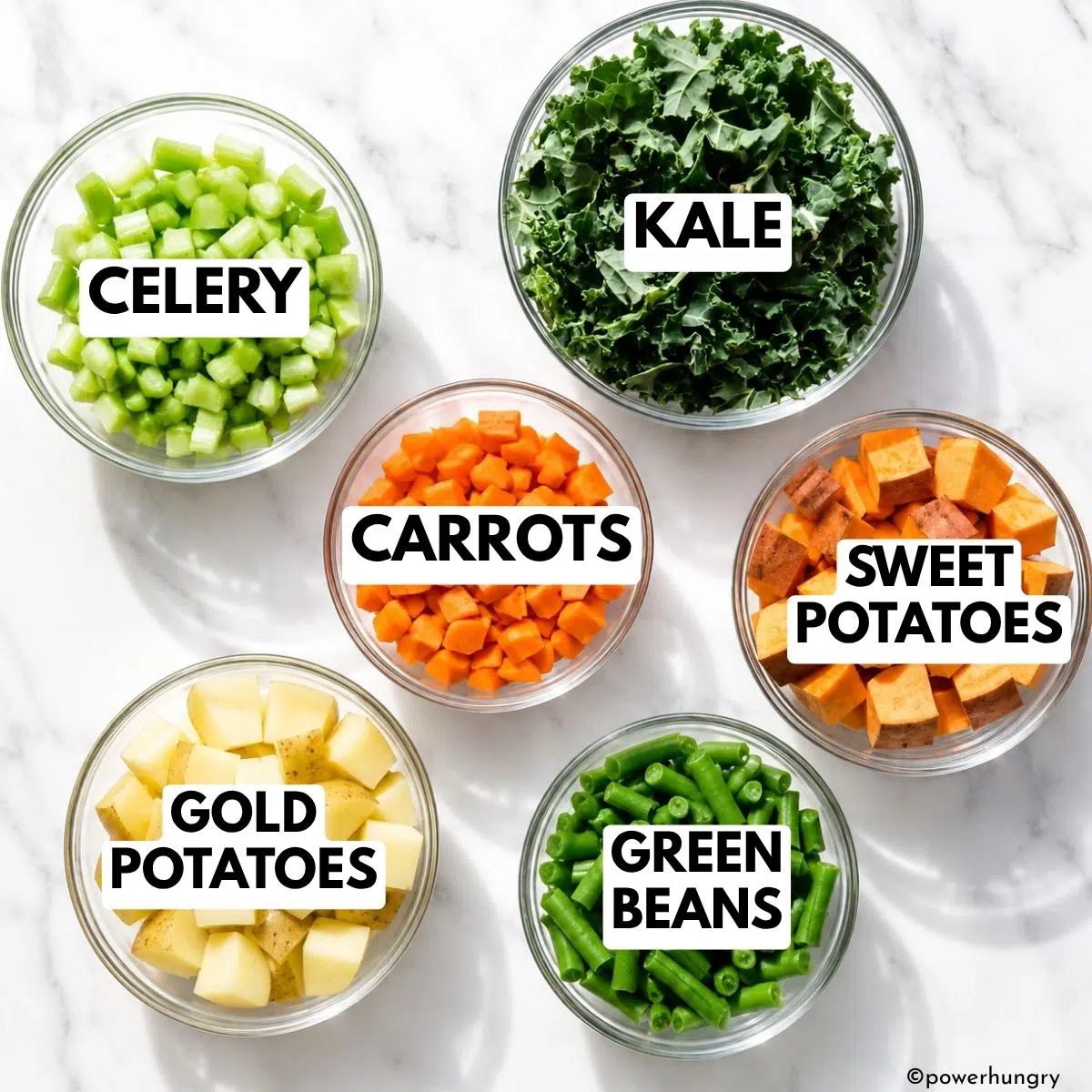 vegetables in glass prep bowl needed to make vegan soup similar to traditional hamburger soup