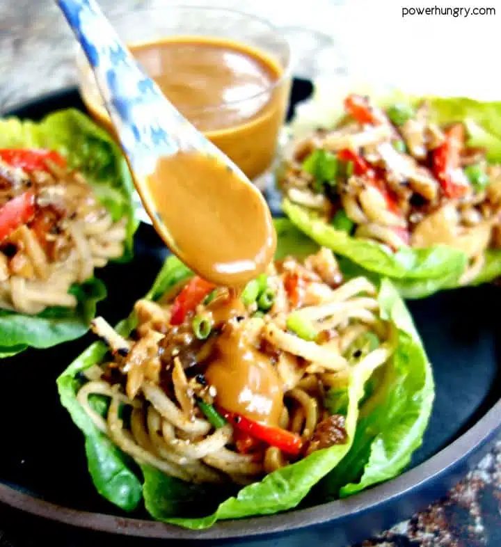 noodle lettuce cup being drizzled with tahini sauce