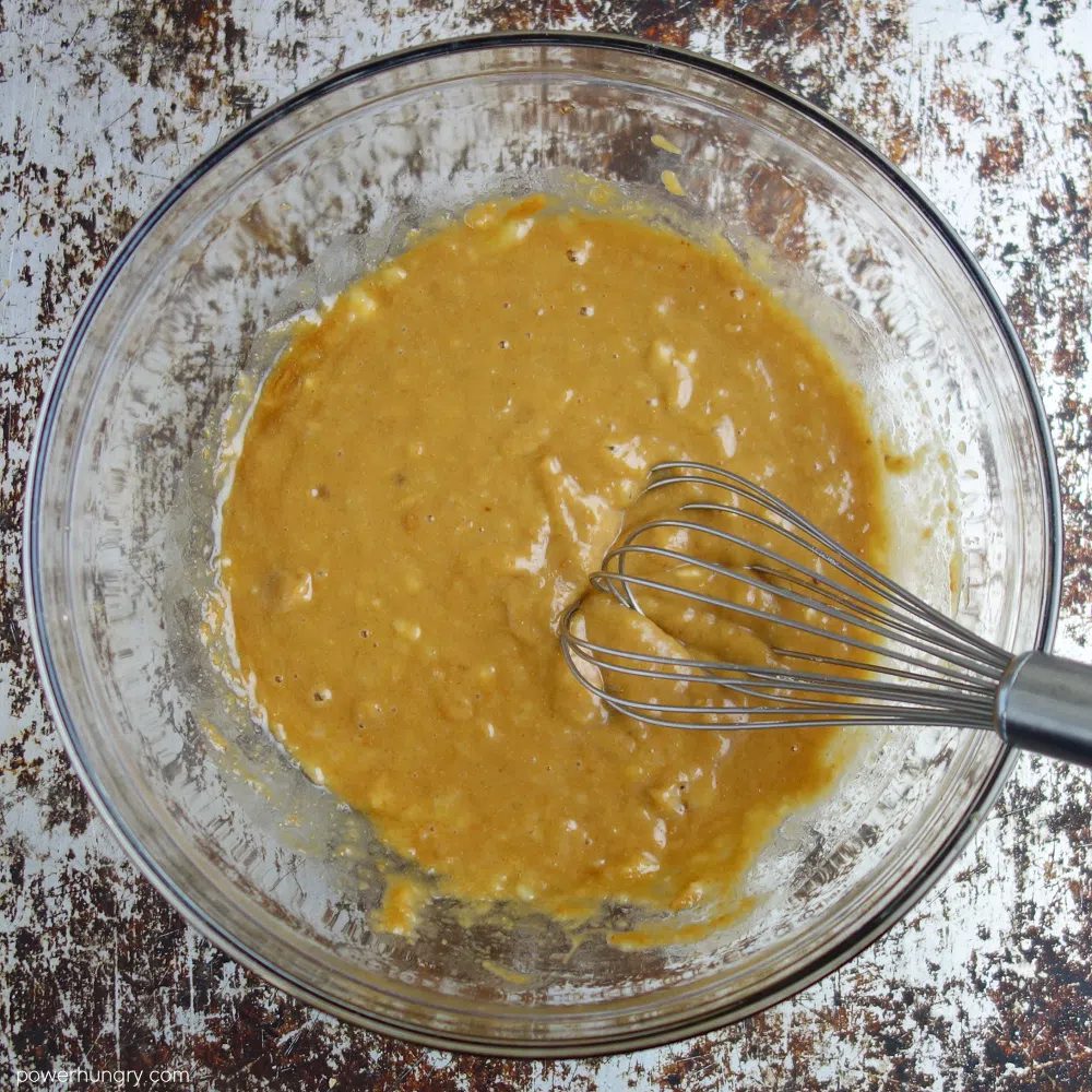 glass bowl filled with combination of banana, nut butter, vanilla and coconut sugar