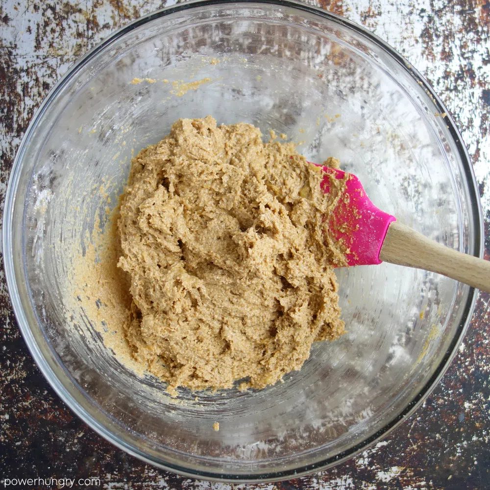banana oat cookie dough in a glass bowl with a pink spatula