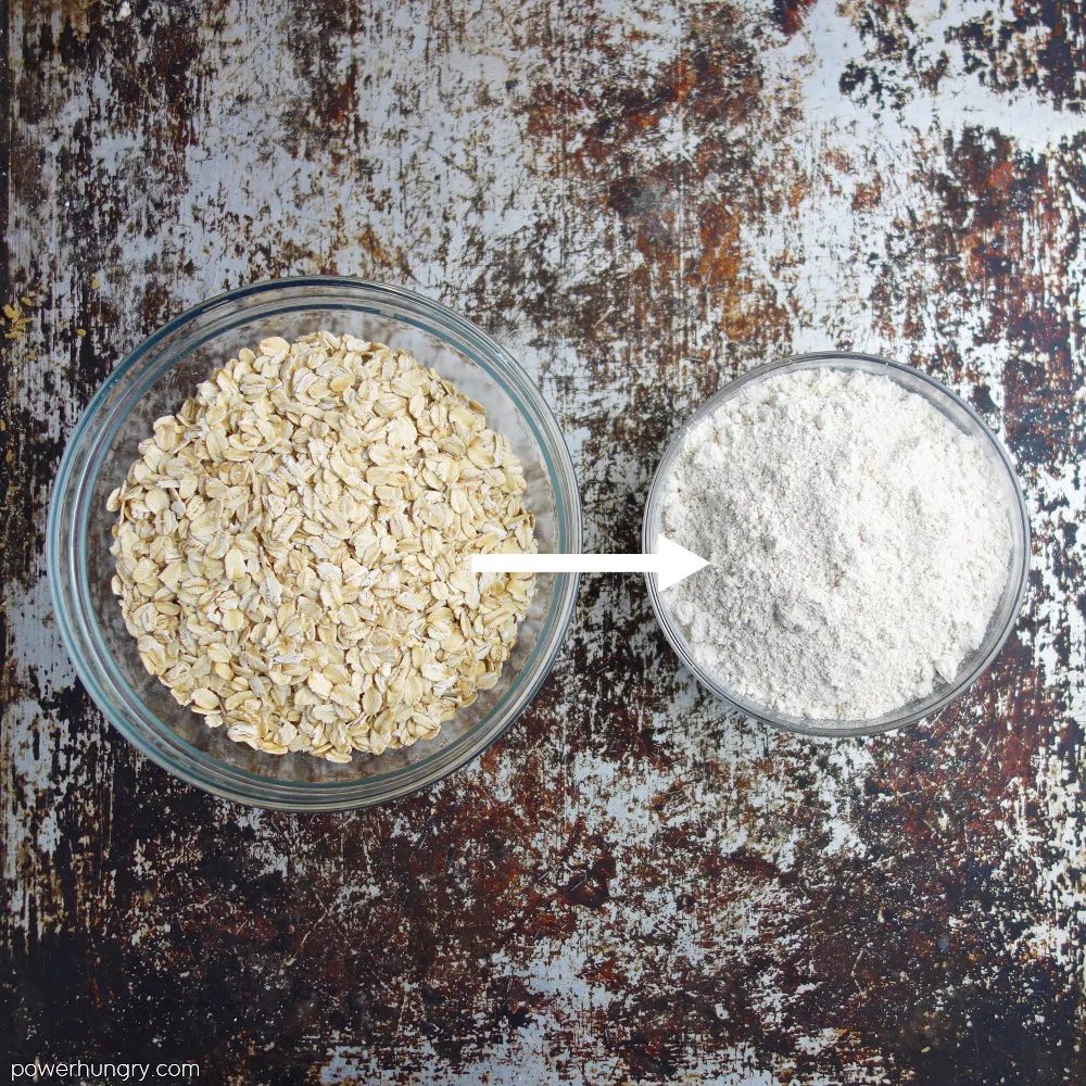 photo showing two glass bowls, one filled with rolled oats, the other with oat flour