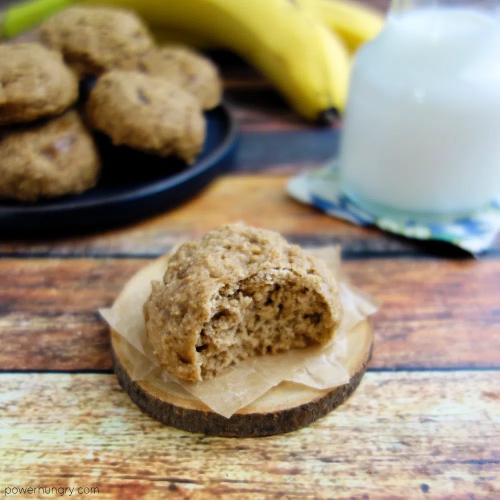 banana oat cookie on a piece of parchment, a bite taken out