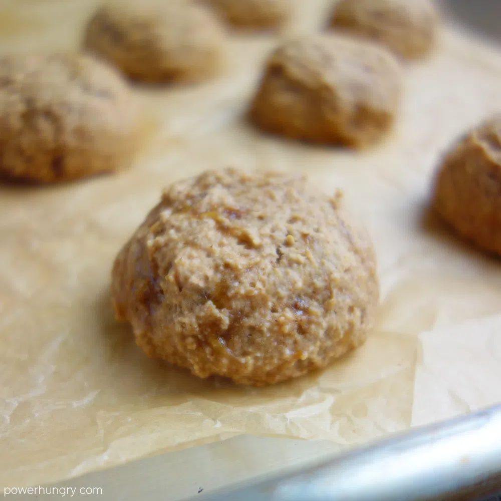 baked banana oat cookies on a parchment paper lined cookie sheet