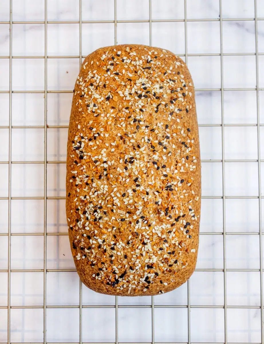 loaf of split pea bread on a metal cooling rack