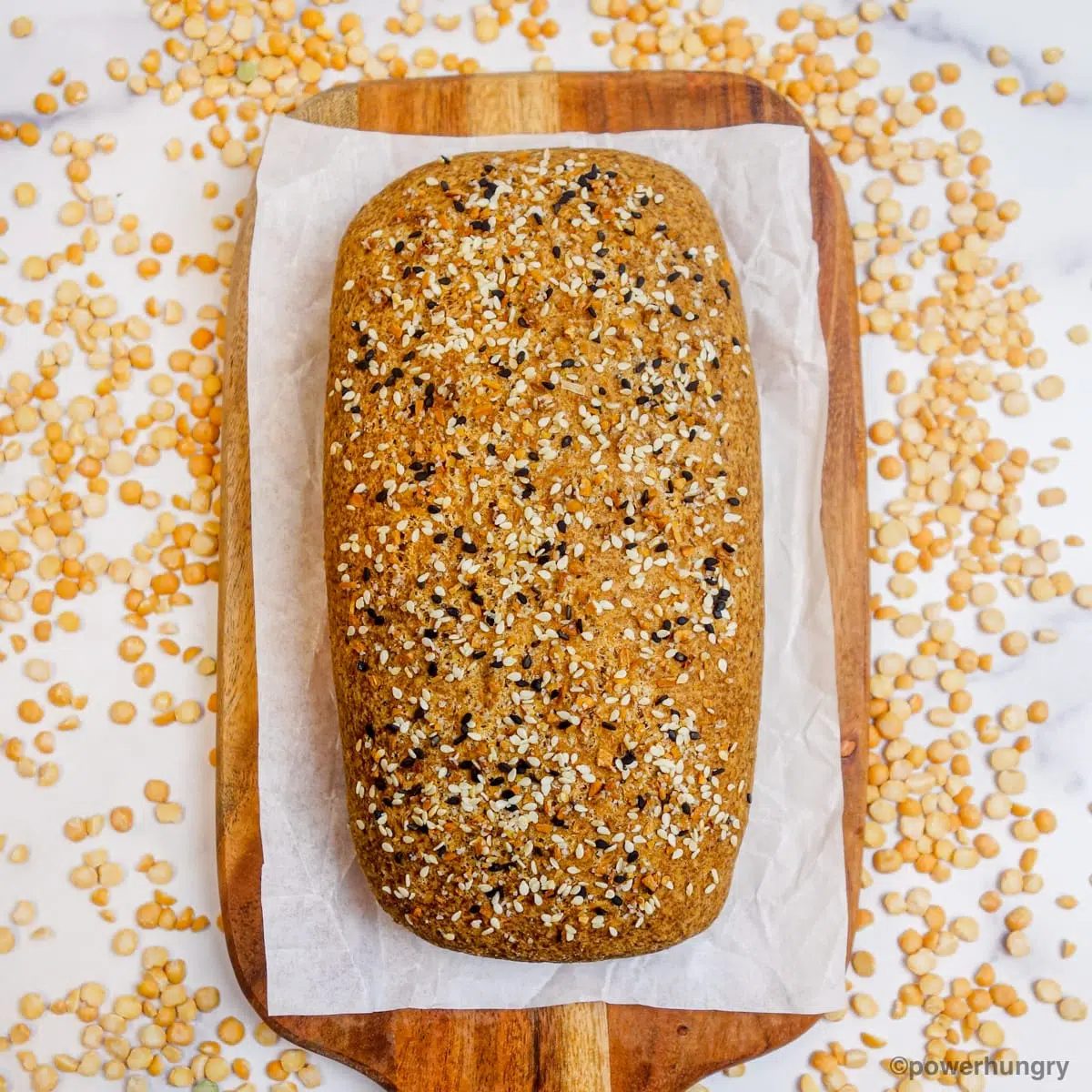 a loaf of split pea bread surrounded by dried split peas