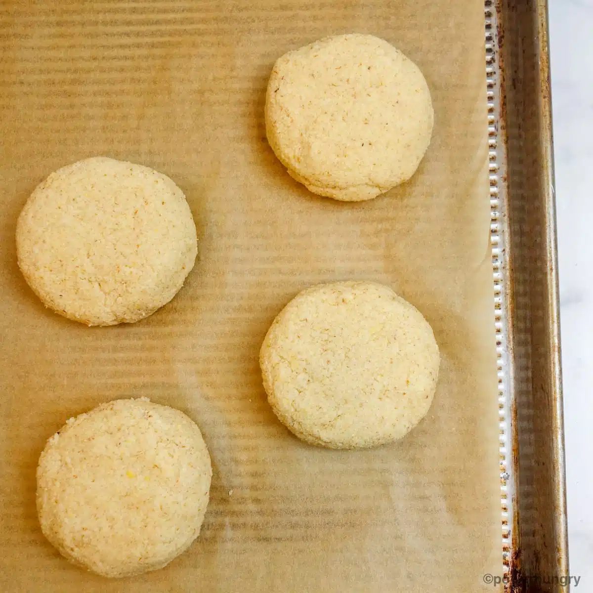 split pea bread shaped into rolls on a baking sheet