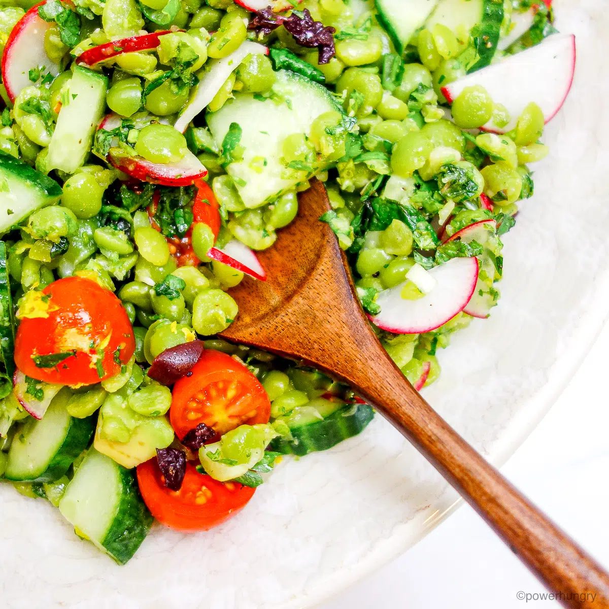 close up of split pea salad in a white bowl