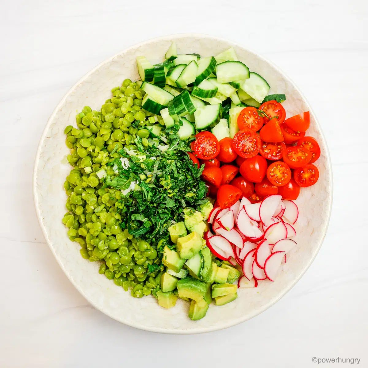 cooked split peas and chopped vegetables in a white bowl