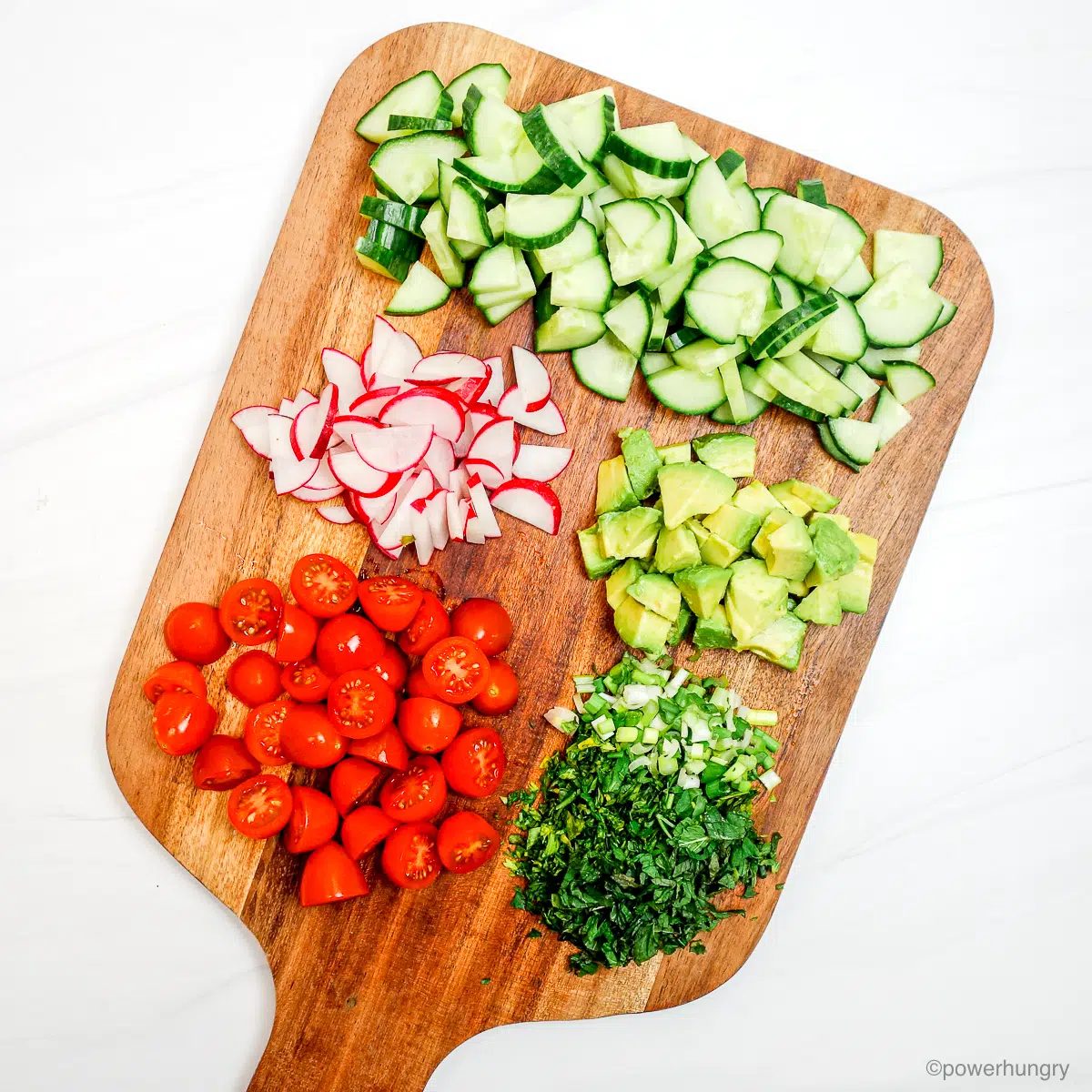 chopped vegetables on a wooden cutting board