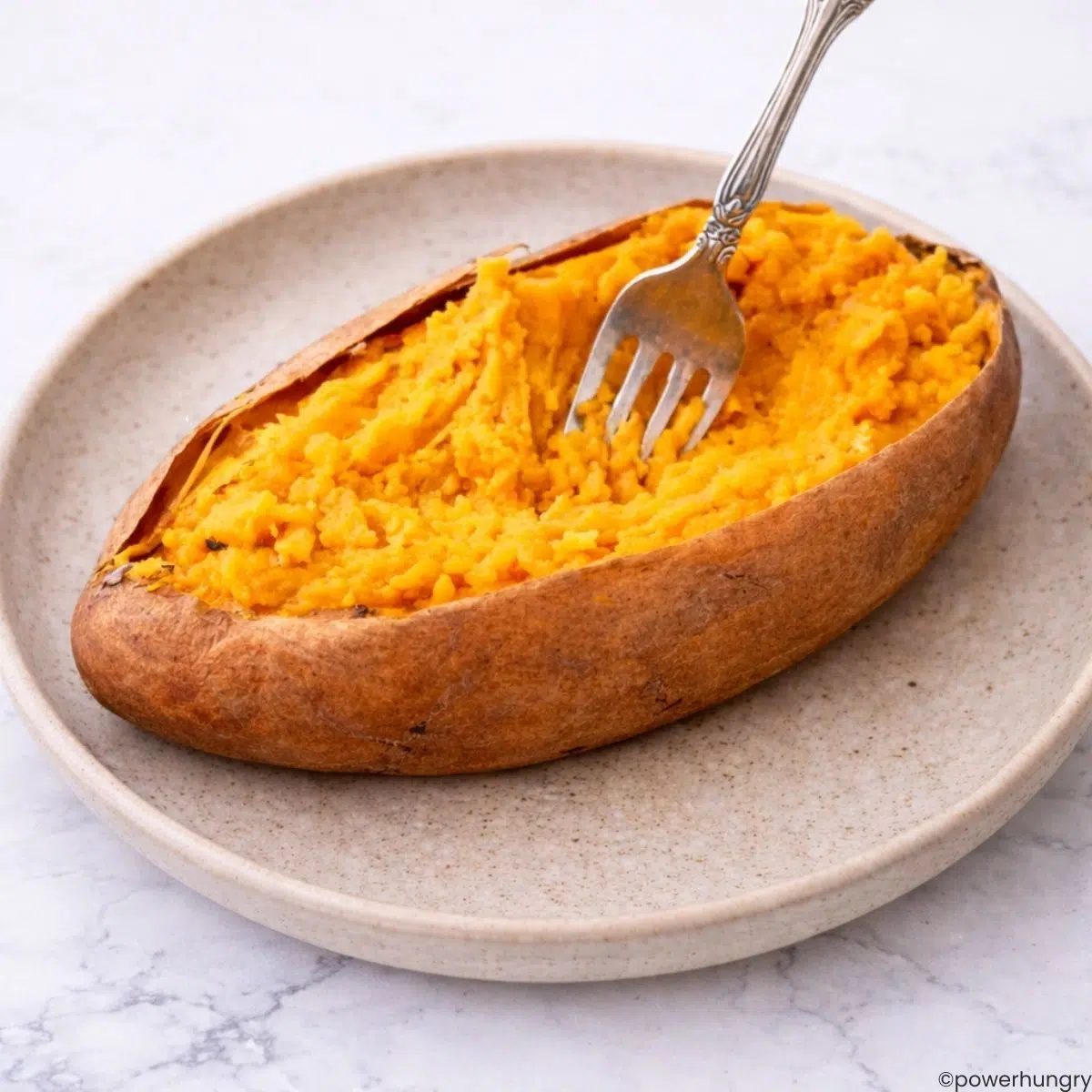 sweet potato , cooked, on a tan plate