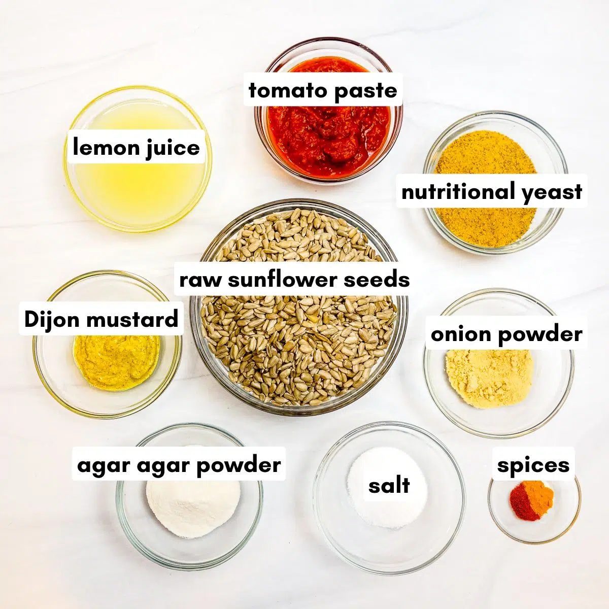 ingredients for vegan sunflower seed Cheddar cheese, all in clear glass bowls